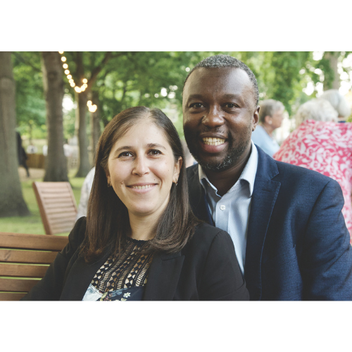 Couple seated in the garden and smiling